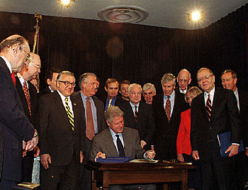 Bill Clinton signing the bill to repeal Glass-Steagall