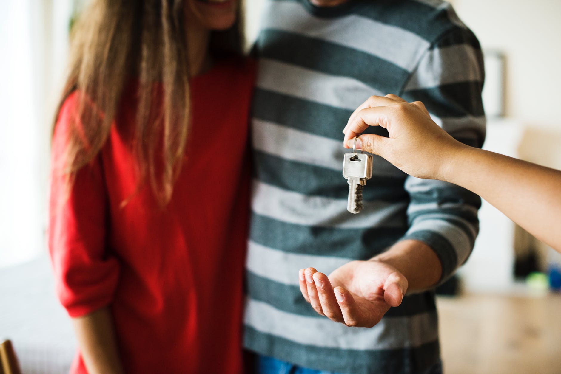 person giving key to the couple