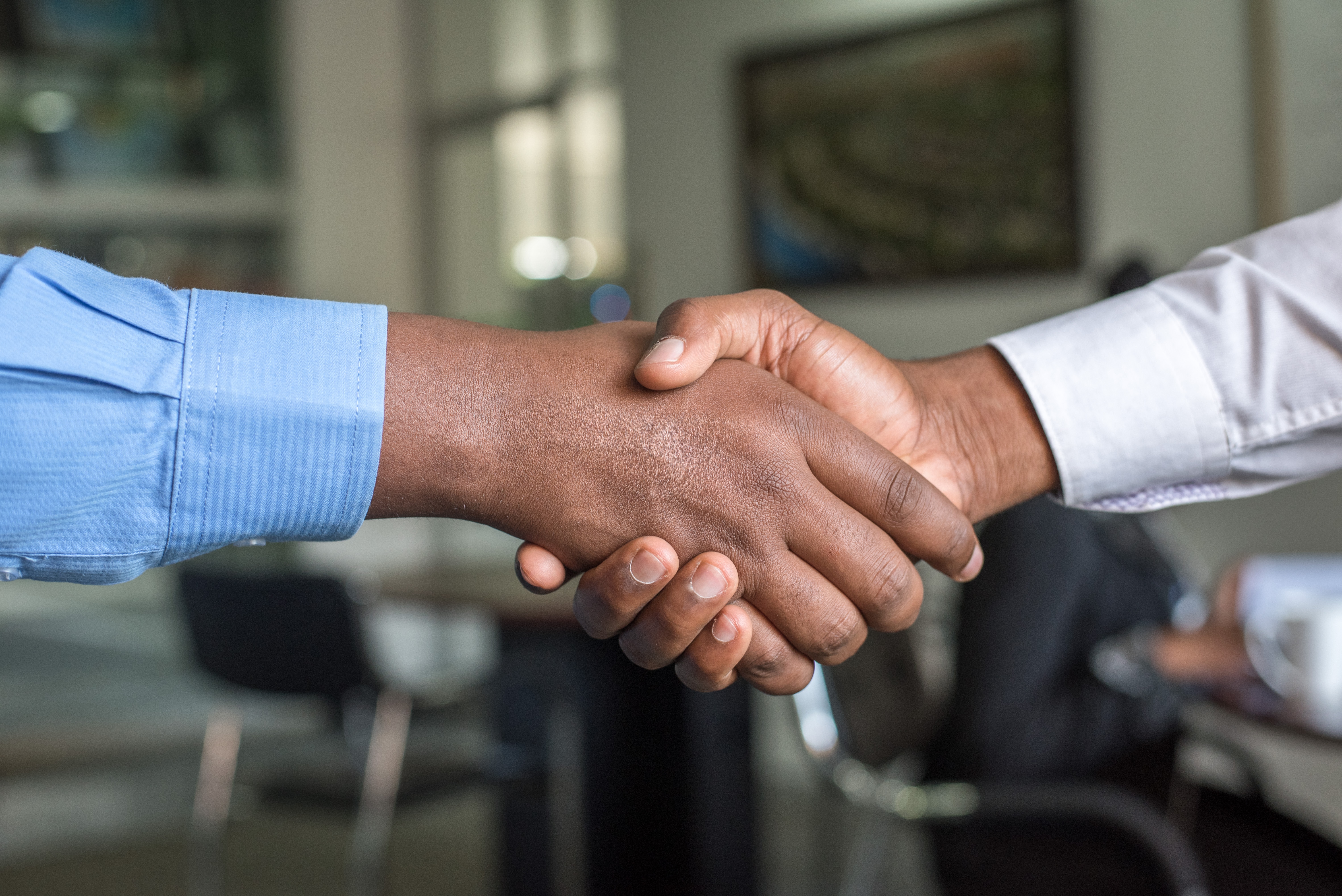 Seller handshaking hands customer